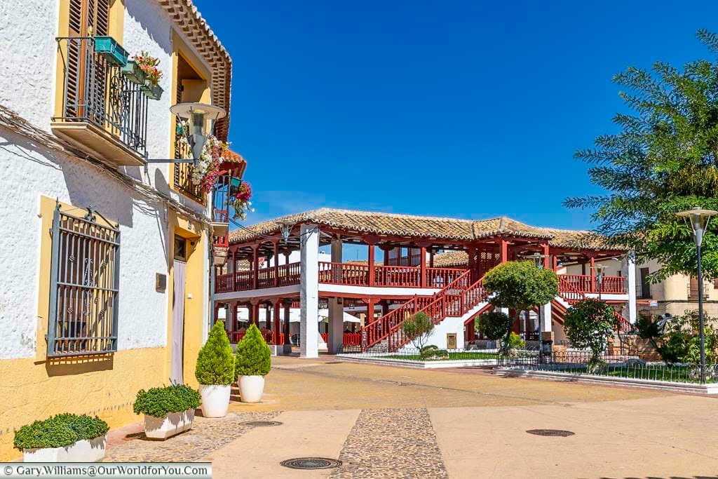 Plaza Porticada, also known as Plaza de las Comedias, is a beautiful plaza in the center of Puerto Lapice, Spain. It is a rectangular plaza with two levels of arcades, the are made of wood and are painted a bright red color.