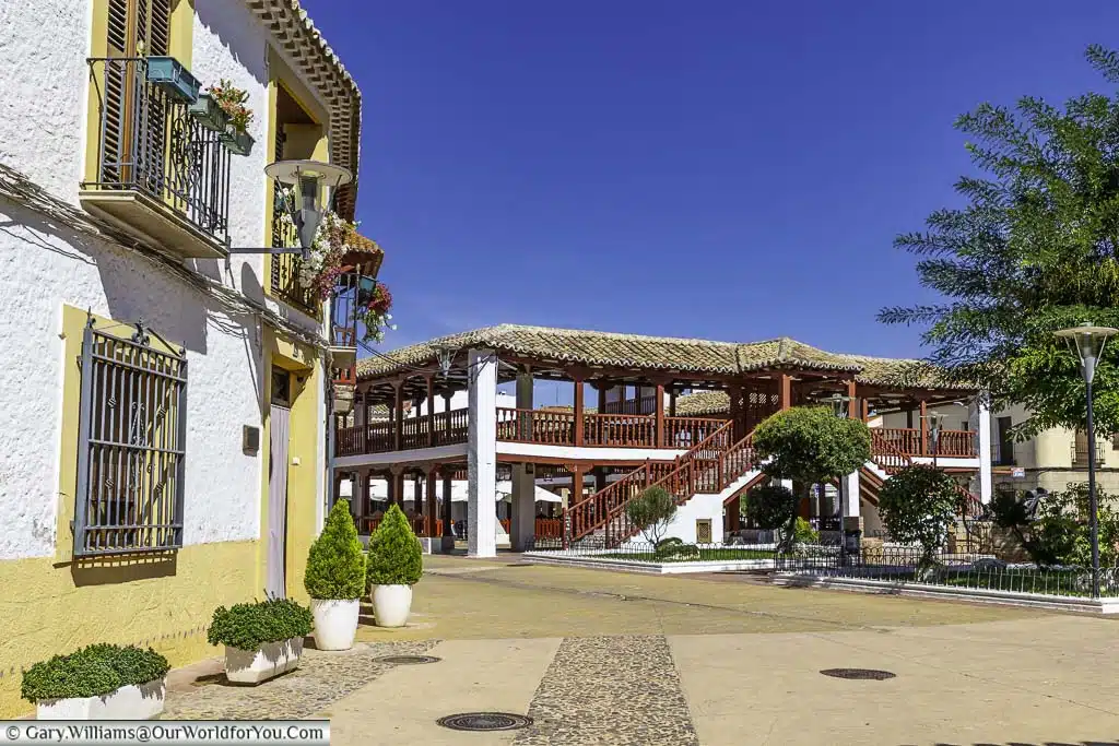 Plaza Porticada, also known as Plaza de las Comedias, is a beautiful plaza in the center of Puerto Lapice, Spain. It is a rectangular plaza with two levels of arcades, the are made of wood and are painted a bright red color.