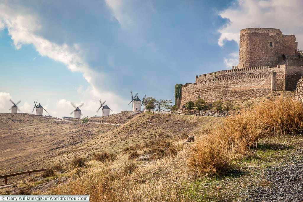 The view up the hill from consuegra castle with five ancient windmills of la mancha in the distance