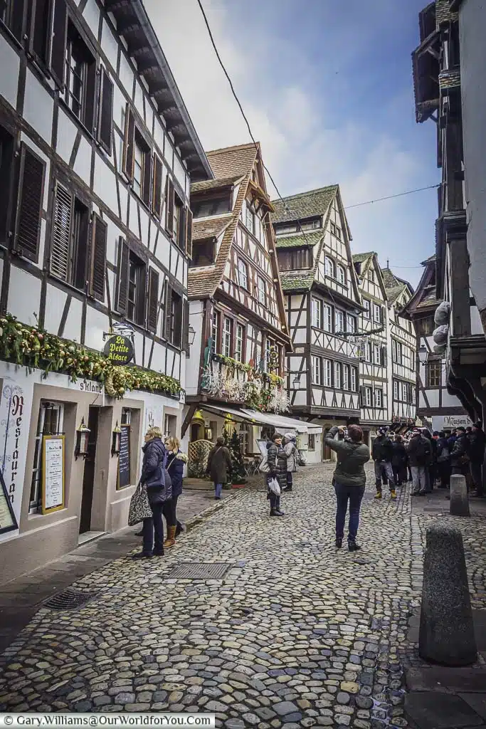 The cobbled lanes of Petite France between the half-timber buildings of this historic quarter of Strasbourg.