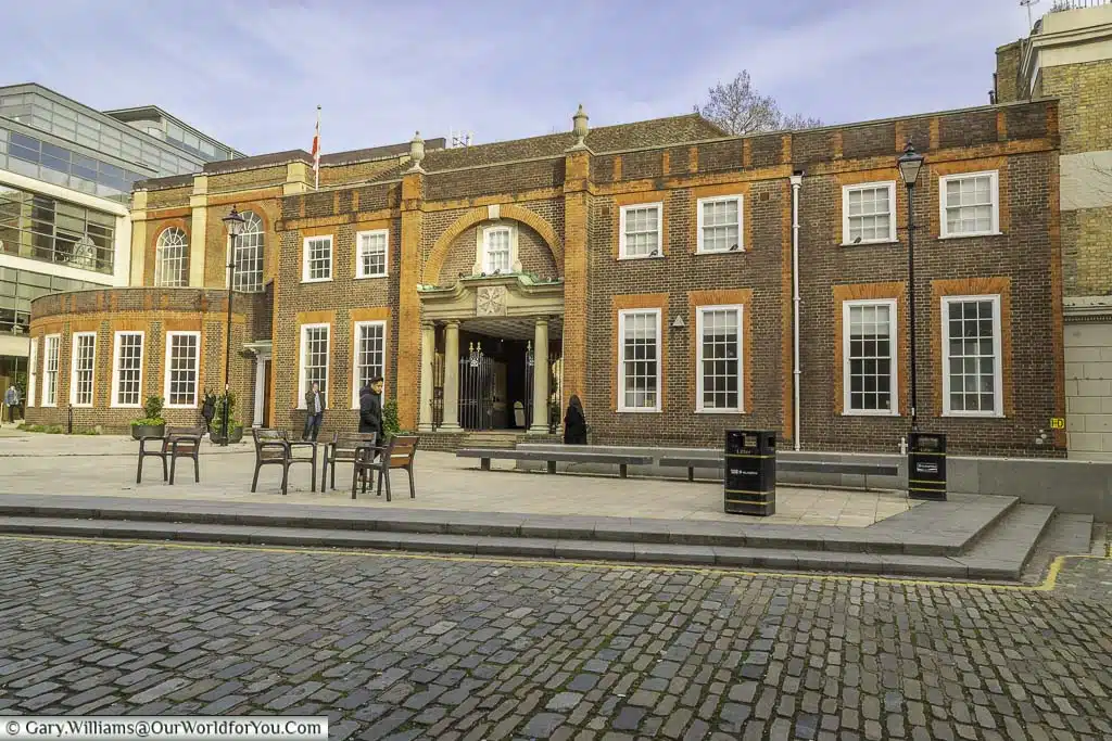 The brick entrance building to the priory church of saint john of jerusalem with an archway leading to the priory gardens in clerkenwell london