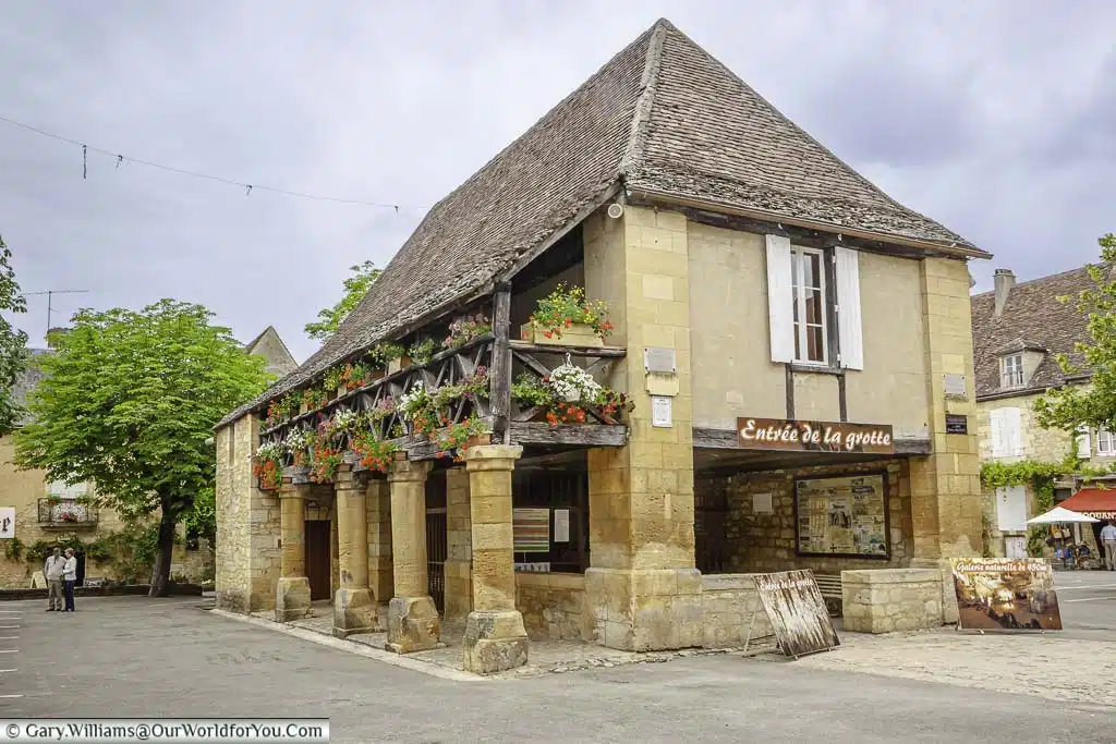The historic stone food hall in the centre of Domme, in the Dordogne region of France, that is now the entrance to the grotto