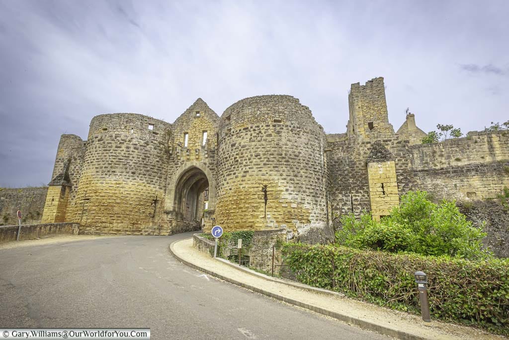 The twin medieval stone towers and gateway at the entrance to domme in the dordogne region of france