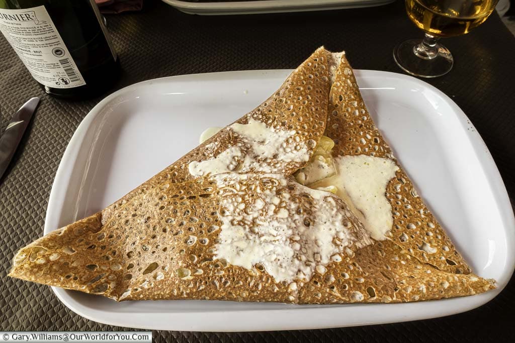 A Breton buckwheat galette filled with camembert cheese and sliced potatoes.