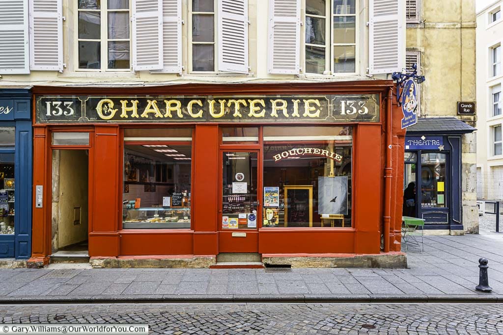 A traditional Charcuterie shop, painted bright red, in the historic town of Troyes