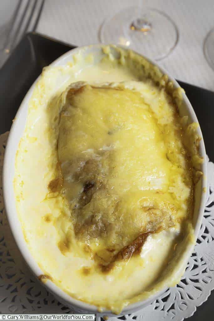 The Ficelle Picarde, a regional dish of Picardy, consisting of a pancake stuffed with cheese, mushrooms and ham, covered in a creamy cheesy sauce served in an oval pie dish