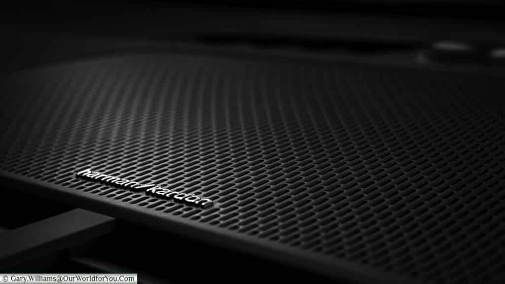 A close-up of the central of the Harman Kardon Premium Sound system speaker on the dashboard of a Polestar 2
