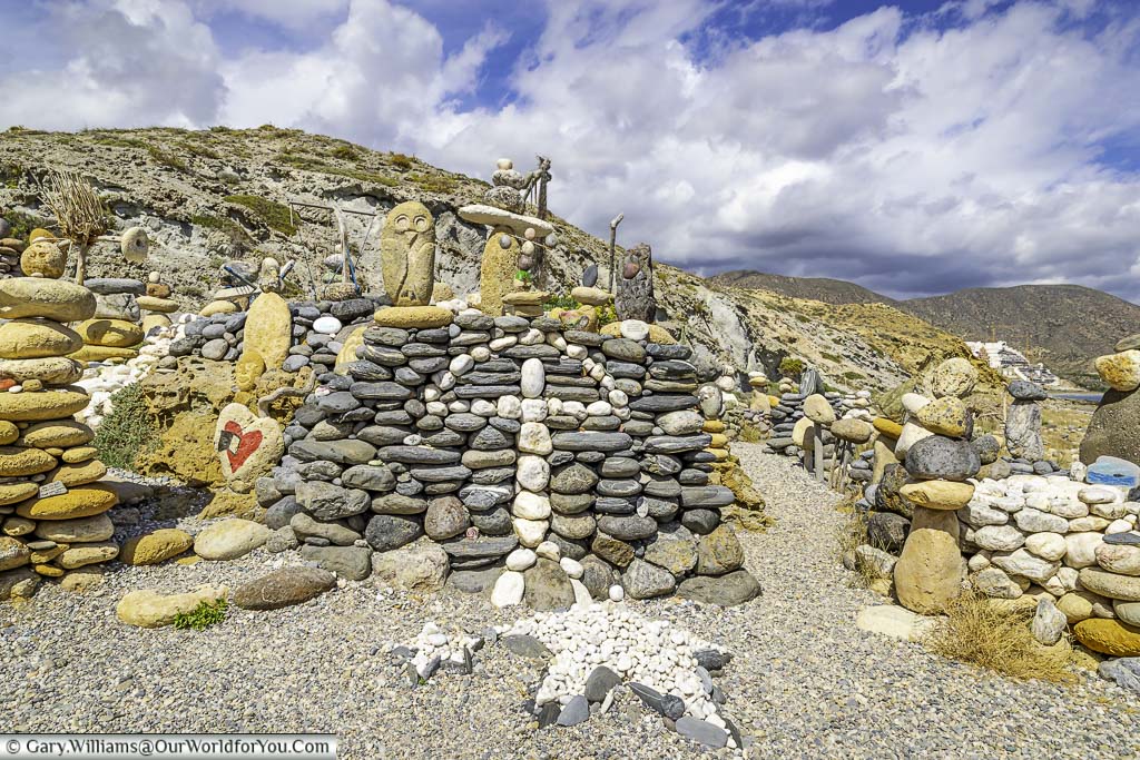 An indalo man created from pebbles on a mound at the templo hippie de Ángel the outside mojácar in andalucia, spain