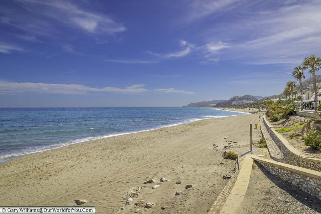 The beach at mojácar playa on the spanish south eastern coastline with golden sandy beaches under blue sky