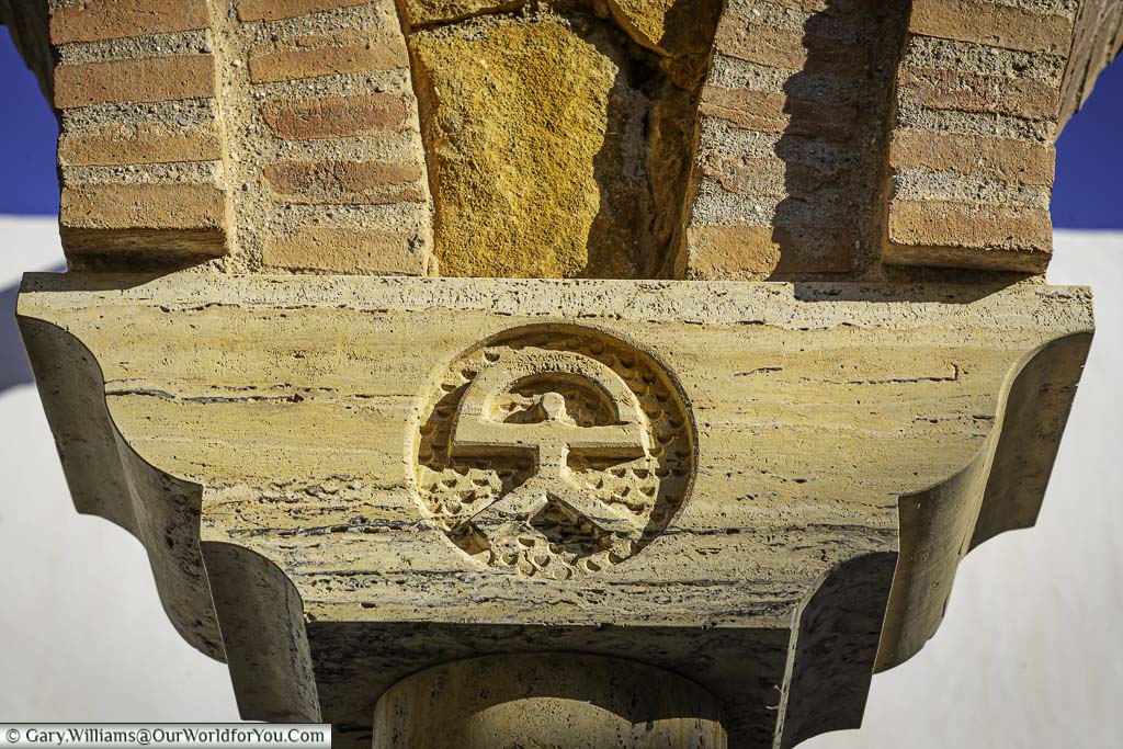 A carved indalo man figure in a stone roof support in old town mojácar, andalucia, spain