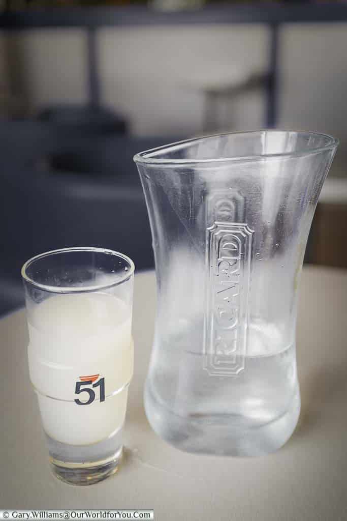 Glass of Richard served with a jug of water for you to mix as you desire. Once you mix the 2 clear liquids the resulting drink turns a cloudy whitish colour