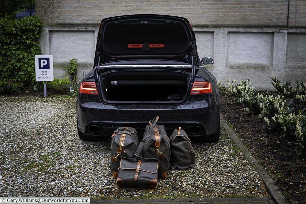 Our luggage stacked in front of the opened boot of our Audi parked in our Utrecht Hotel cark park