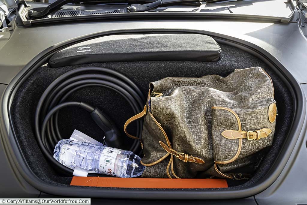 The front storage area of a polestar 2 is where you would normally expect to find an engine, in this case, containing a rucksack, recharging cable and a large bottle of water