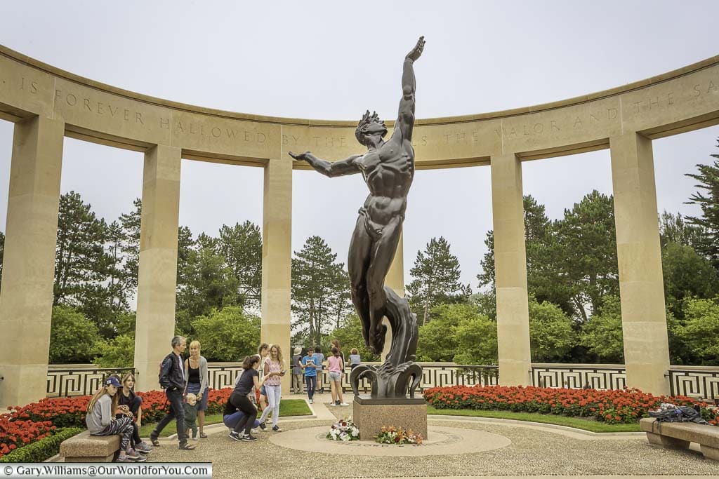 The 'Spirit of American Youth Rising from the Waves' statue in the centre of the memorial garden at the Normandy American Cemetery.