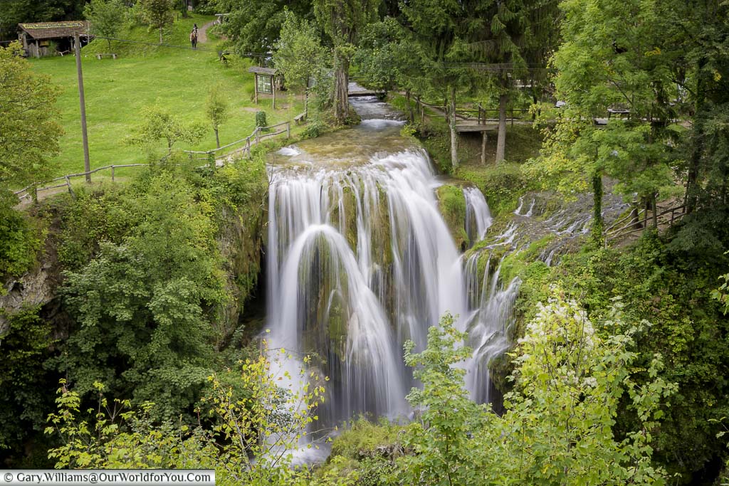 Water flowing over rocks against the lush green background of Rastoke in Croatia