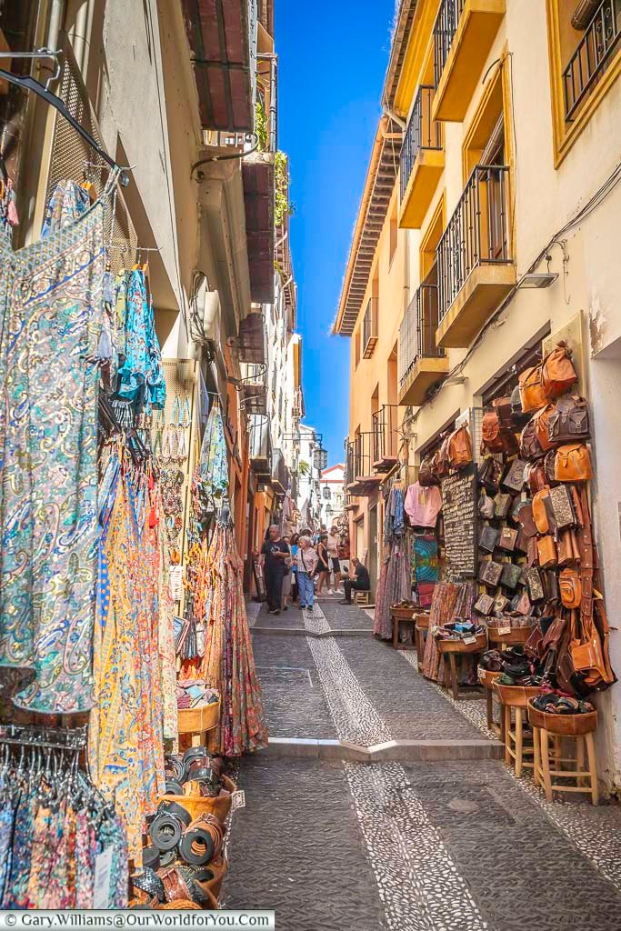 the view along bustling lane of calle calderia nueva in granada, southern spain