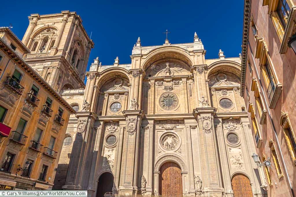 The ocre coloured grand facade to granada's cathedral in andalusia, southern spain