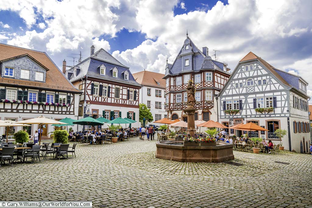 The view of market platz with its stone fountain taking centre stage against the backdrop of half-timbered buildings