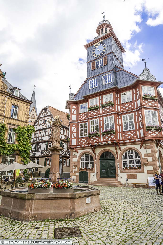 The stone fountain In the centre of market platz in front of Heppenheim's half-timbered town hall.