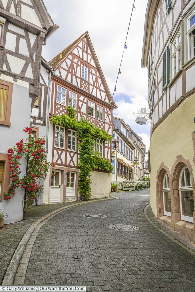A cobbled lane leading past half-timbered houses towards the centre of the Old Town of Heppenheim.
