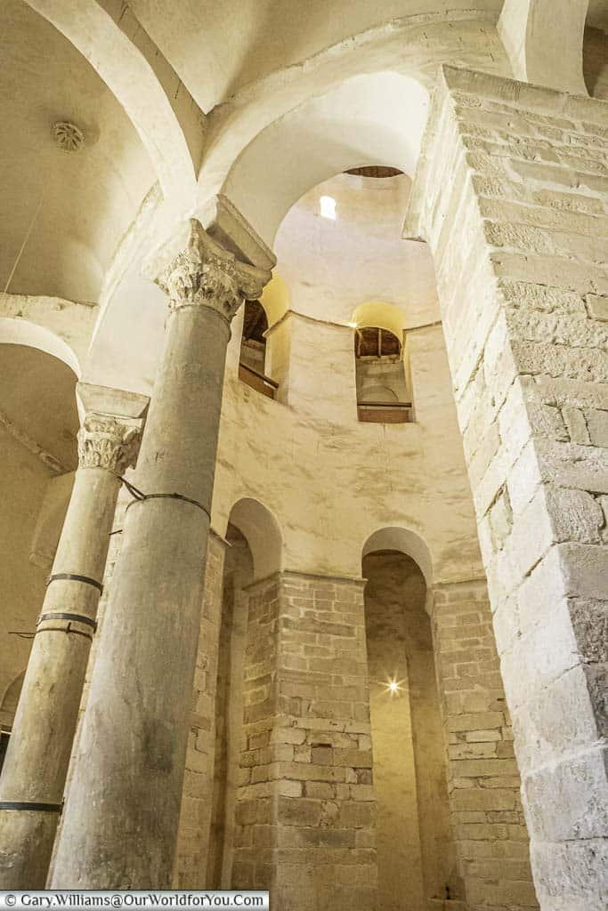Looking up at the thick stone columns inside st donatus church in zadar croatia,