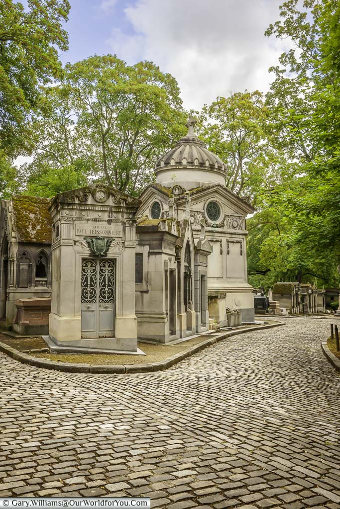 A collection of family mausalems at a junction in the Père Lachaise Cemetery in Paris