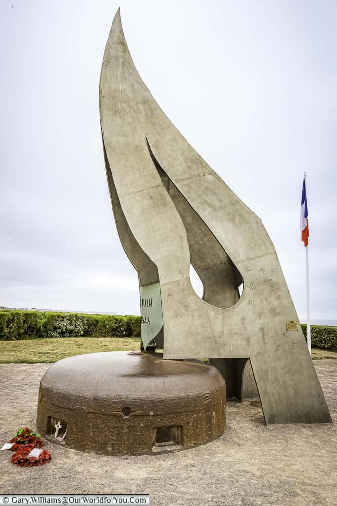 An image of the memorial "La Flamme"; a large metal flame housed on top of a German bunker.