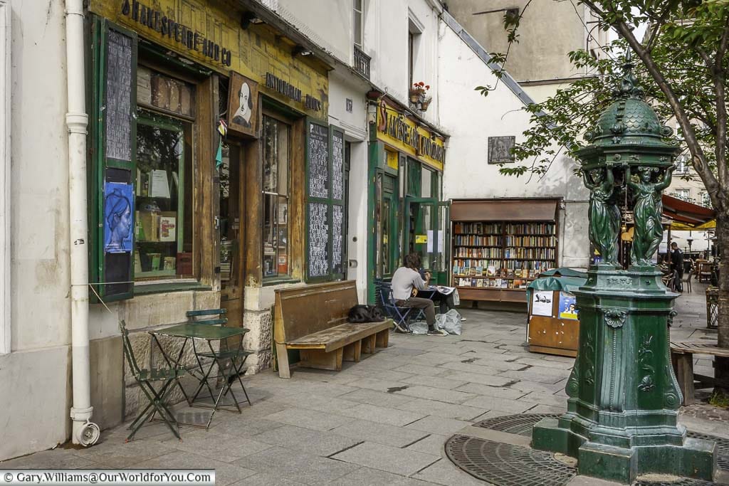 The historic Shakespeare and Co bookstore with the cast iron Wallace fountain, providing free drinking water to all in Paris