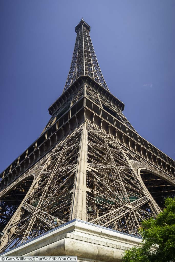Looking upwards to the Eiffel Tower on a bright day in Paris