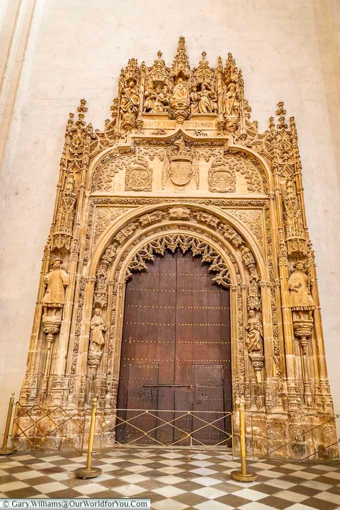 The massive wooden door with its ornate facade that leads to the royal chapel in granada's cathedral in andalusia, southern spain