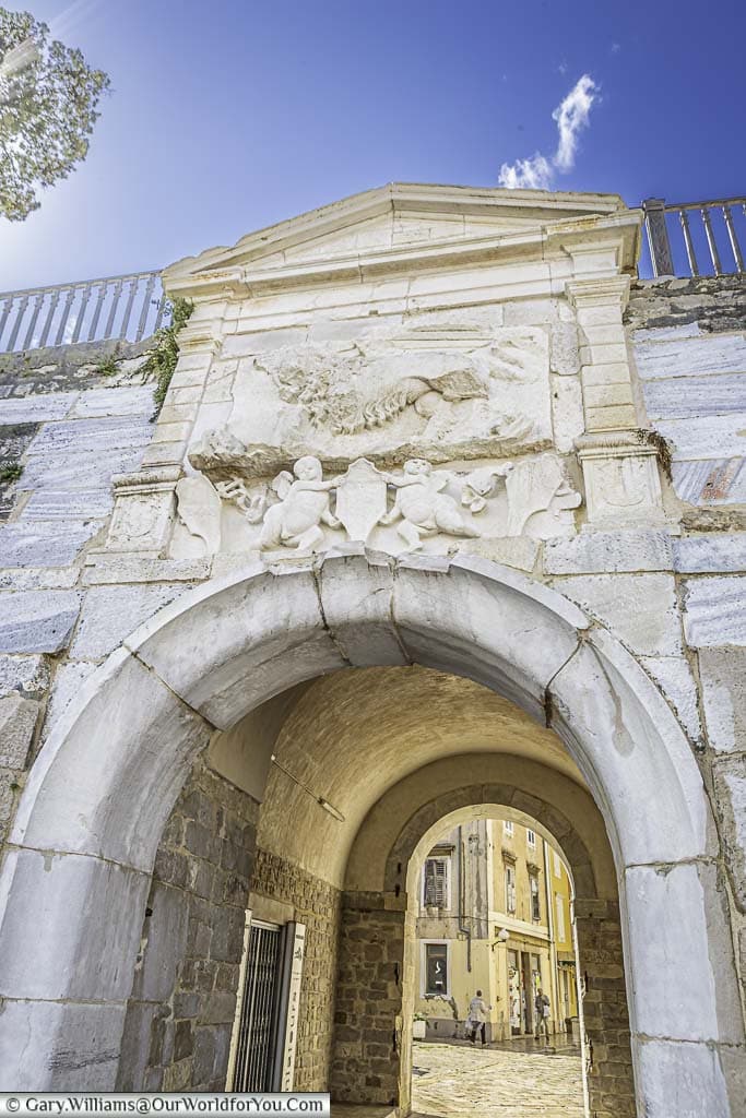 The historic sea gate in zadar's city walls. A marble archway, with the winged lion of st. mark, a symbol of venetian rule, leading to the old city centre.