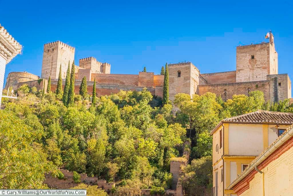 the view from carrera del darro looking up to the alhambra palace in granada, southern spain