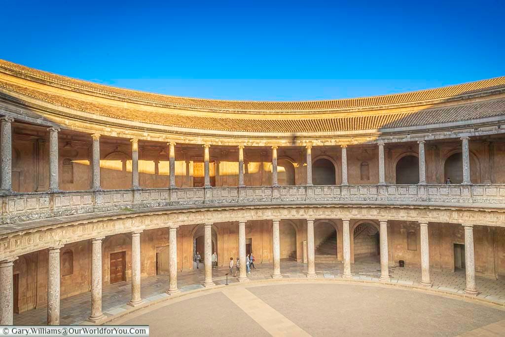 Looking down on the collonaded interior courtyard within the palace of charles v in the alhambra in granada, spain