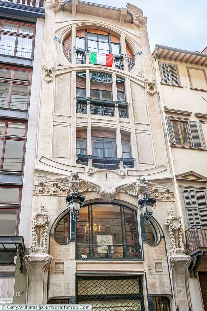a beautiful five storey art deco style building on a street in florence, italy