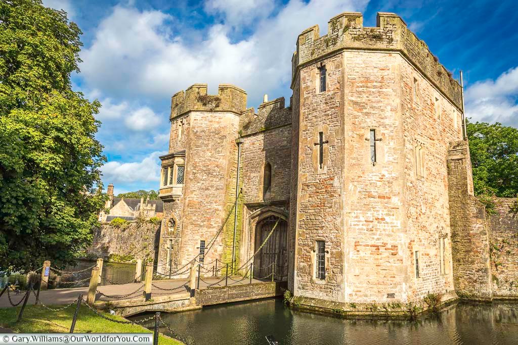 The two towers either side of the drawbridge that crosses the moat around the archbishops palace in wells, somerset