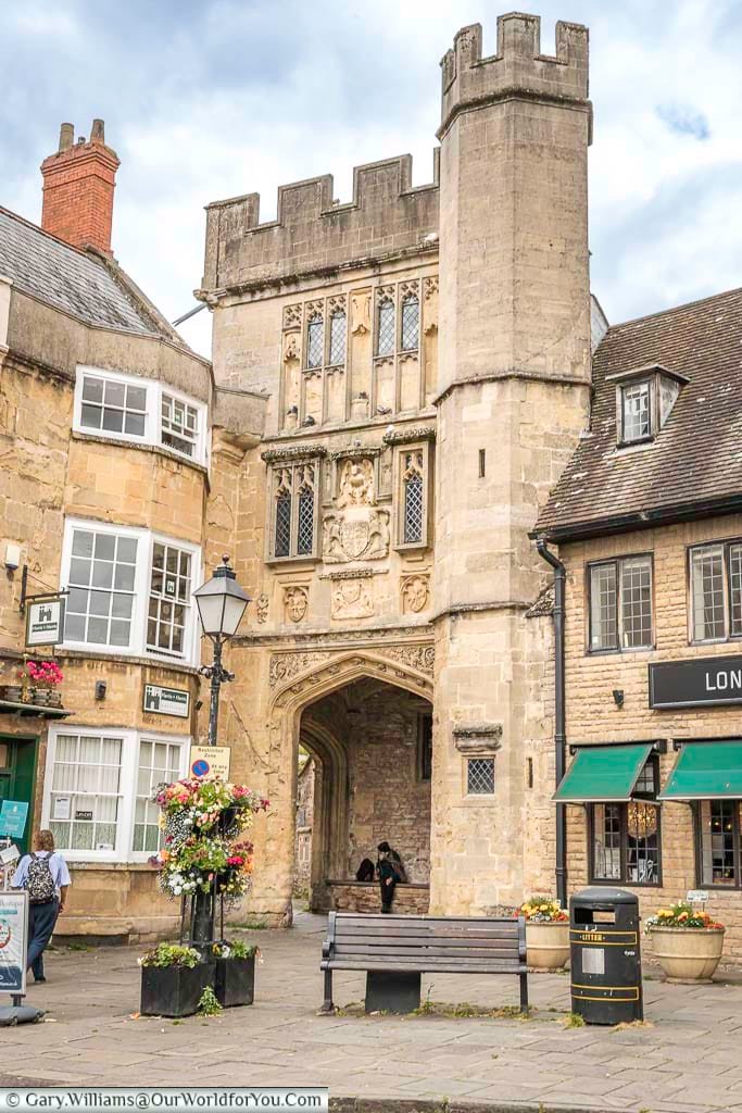 The crenulated stone tower with the penniless porch at its base just off wells market place in somerset