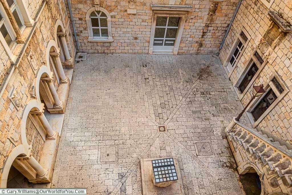 Looking down to the stone courtyard of the old town hall in historic trogir, croatia