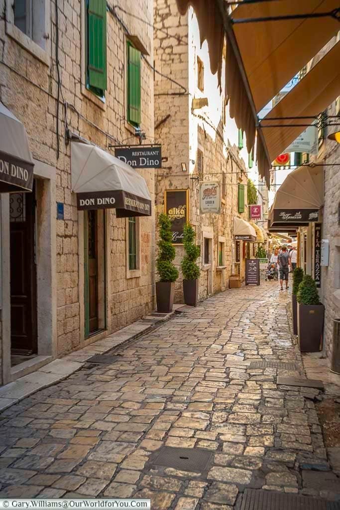 A narrow cobbled lane full of shops in the centre of old trogir, croatia