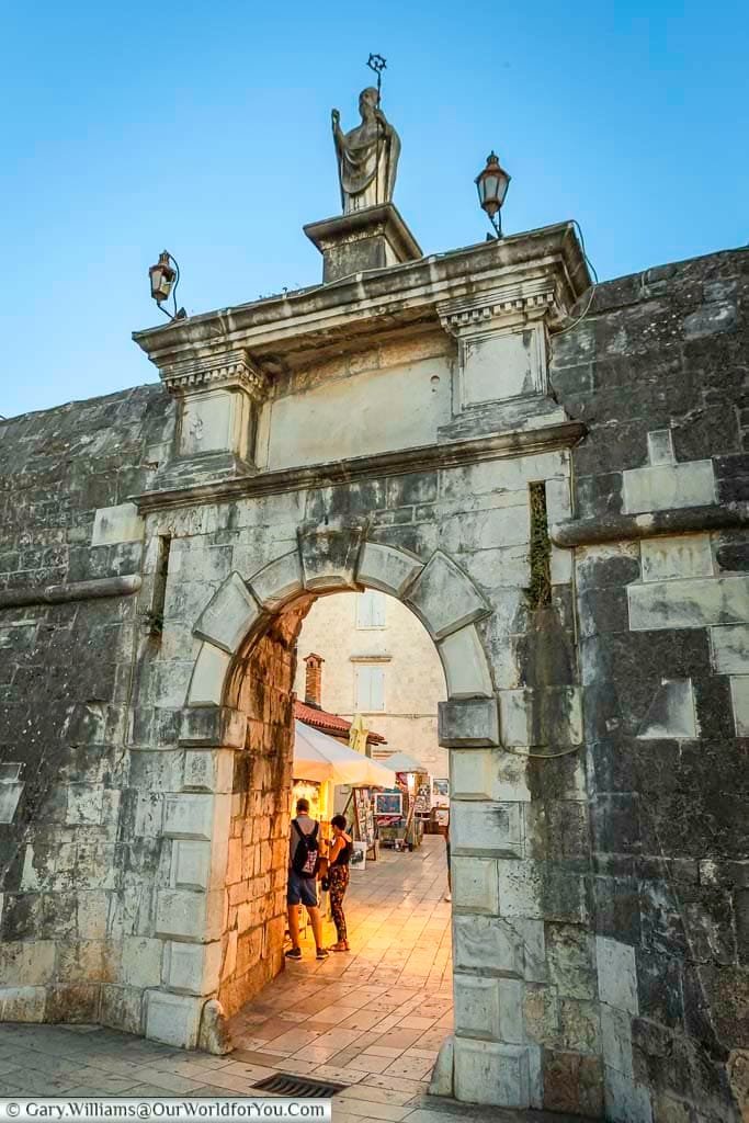 The stone north gate, built into the city walls of trogir, croatia, at dusk