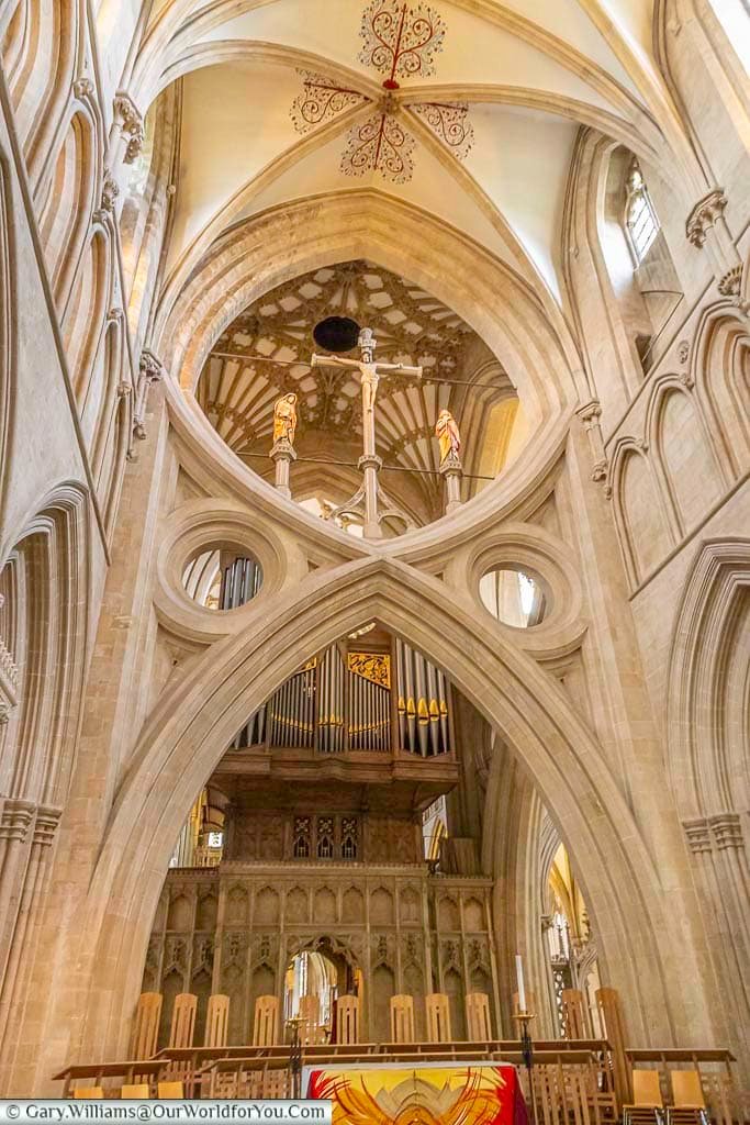 the scissor arch in front of the altar of wells cathedral with a glimpse of the cathedral organ in the background