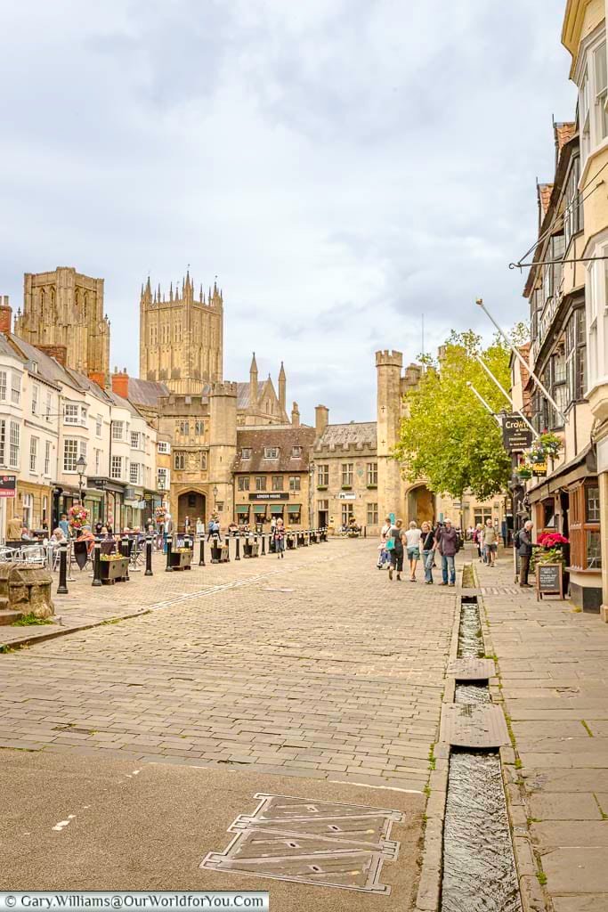 A view of wells market place with the water gully running through it and past the crown inn