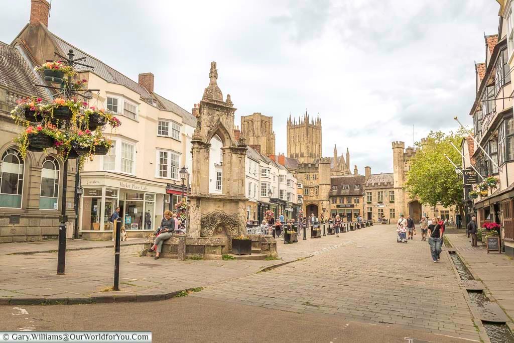 The market place at wells with its iconic fountain in the foreground and the iconic towers of wells cathedral in the background