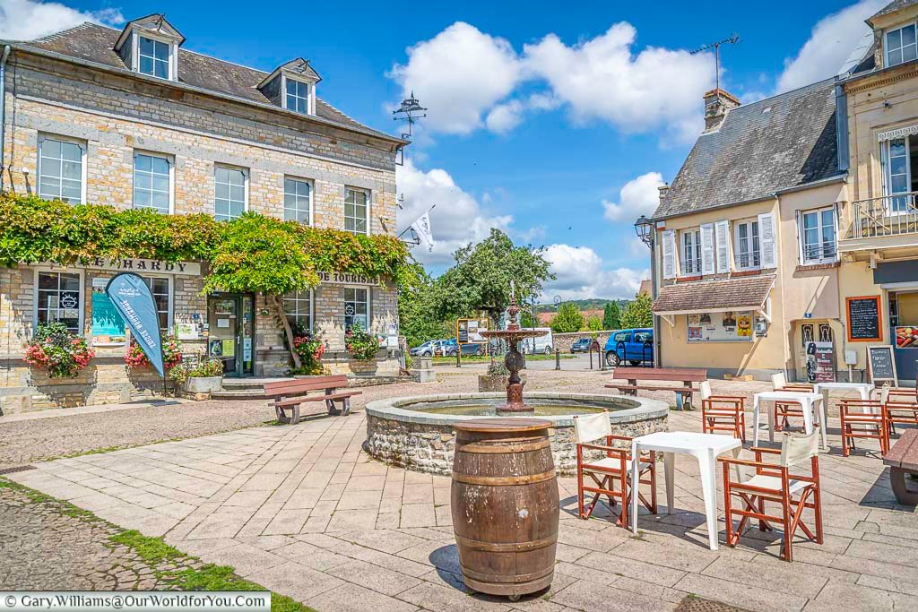 A fountain in the centre of the pretty little village of clécy, normandy on a bright day in july