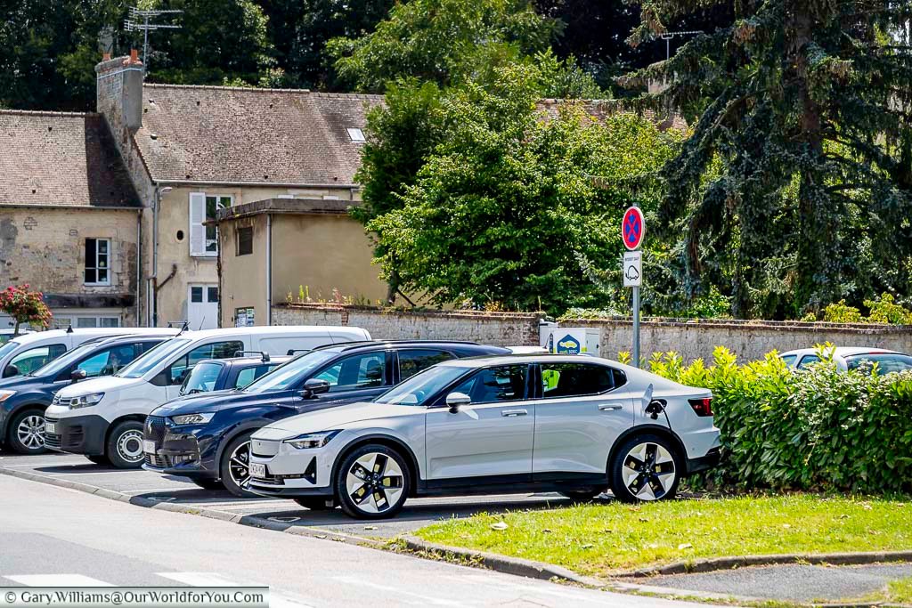 Our polestar 2 electric car on charge at a car park in falaise, normandy, france