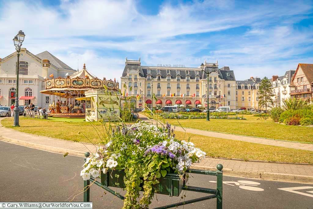 The jardin du casino with a small carousel in front of the grand hotel in cabourg, normandy