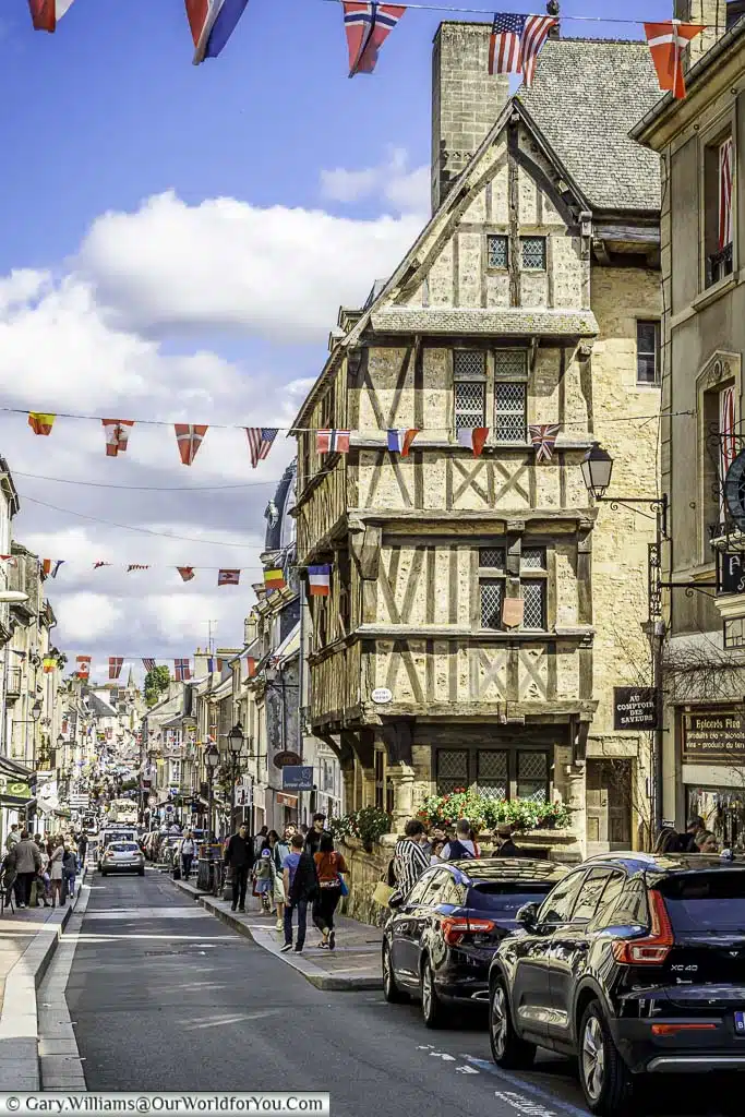 The bunting lined rue saint-martin in bayeux from the historic maison à pans de bois de la rue des cuisiniers
