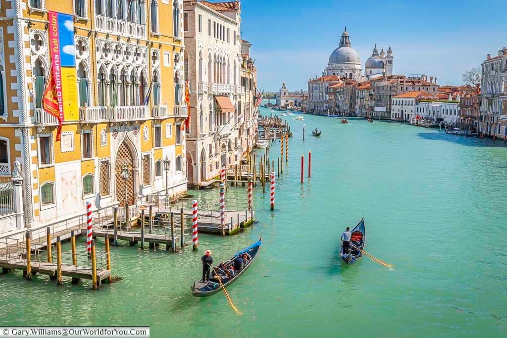 The view along the Grand Canal in Venice, complete with gondoliers, towards the Basilica di Santa Maria della Salute from Ponte dell'Accademia