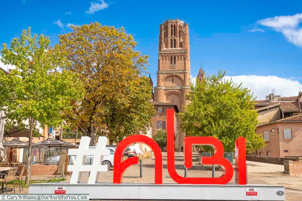 The hashtag albi sign with the cathedral tower in the background in southern france