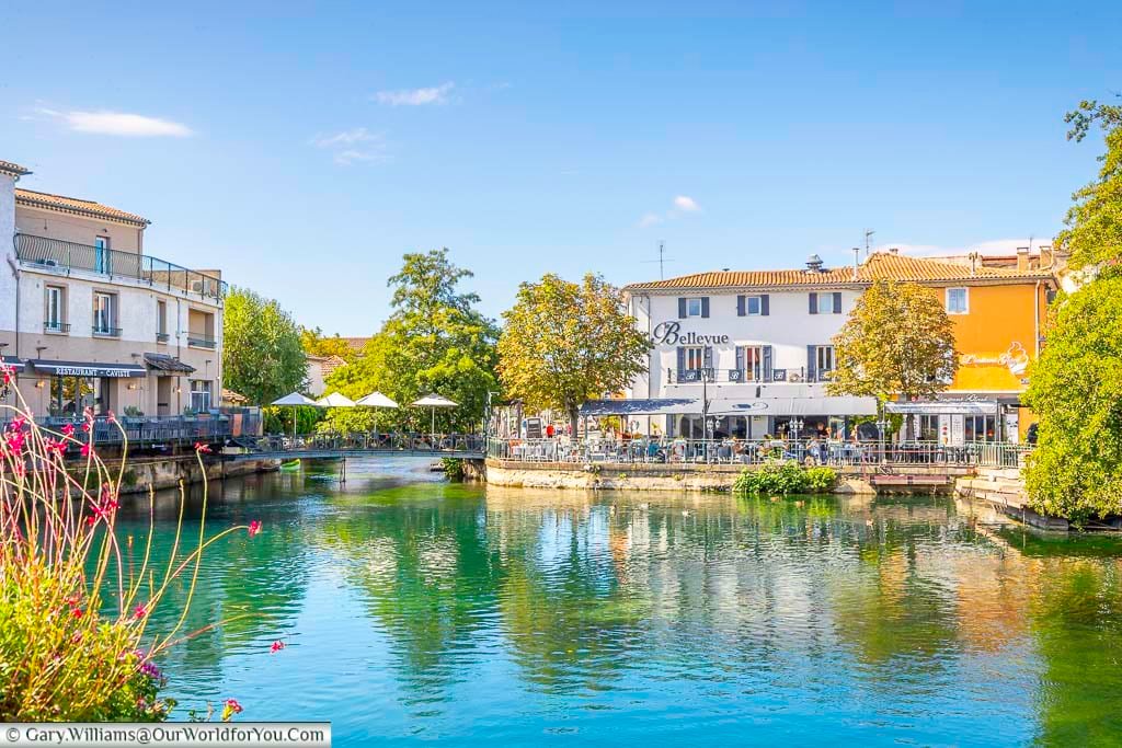 Restaurants linning the bassin bouïgas on the edge of the provence town of the l'isle-sur-la-sorgue in southern france