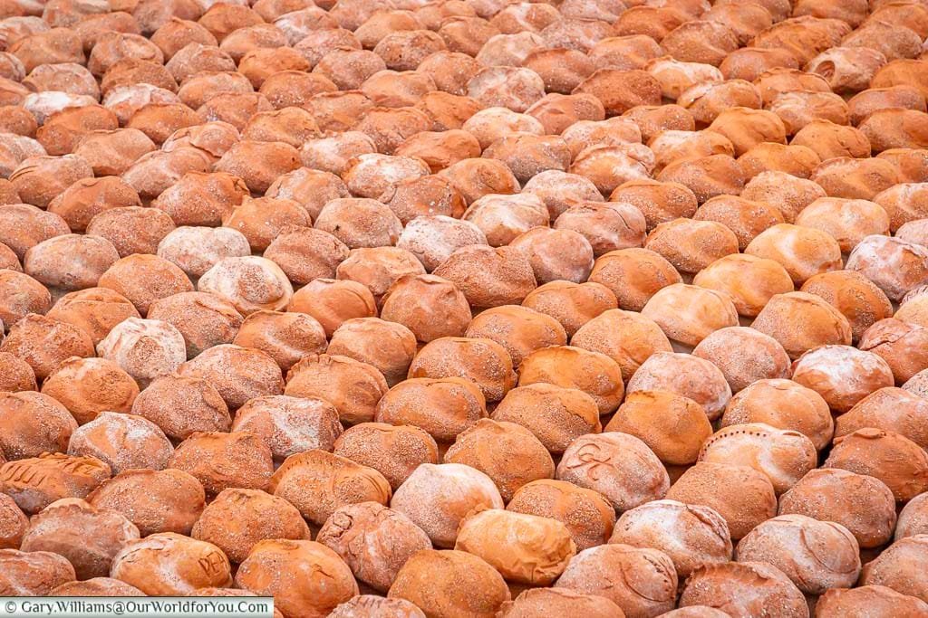 A close up of a selection of tightly packed little terracota figurines of crouched world war one soldiers at the Coming World Remember Me installation at the Palingbeek provincial park in belgiu